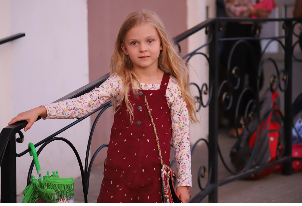 girl by wrought iron railing